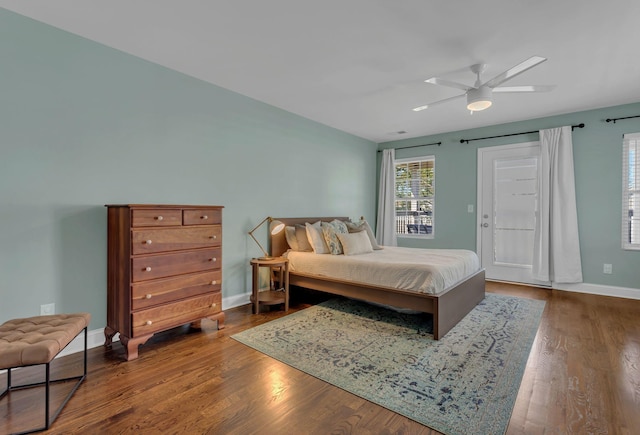 bedroom with ceiling fan, wood-type flooring, and access to outside