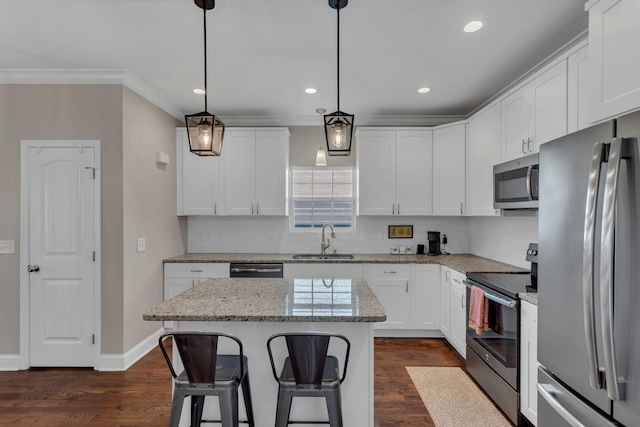 kitchen with white cabinetry, hanging light fixtures, stainless steel appliances, a center island, and sink