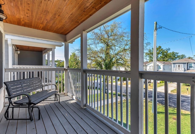 wooden deck with a lawn