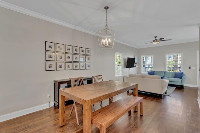 dining area with dark hardwood / wood-style flooring, crown molding, and a healthy amount of sunlight