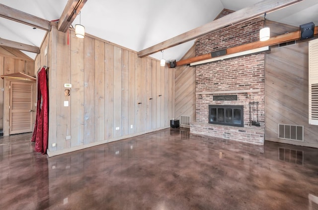 unfurnished living room with wood walls, lofted ceiling with beams, and a fireplace