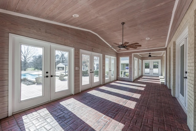 unfurnished sunroom featuring french doors, vaulted ceiling, and wooden ceiling