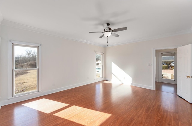 empty room with ornamental molding, hardwood / wood-style floors, and ceiling fan