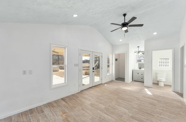 unfurnished bedroom with french doors, lofted ceiling, access to exterior, light hardwood / wood-style floors, and sink