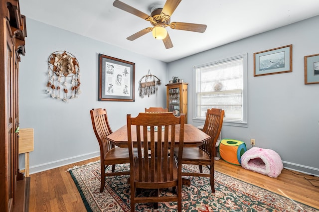 dining space featuring hardwood / wood-style flooring and ceiling fan