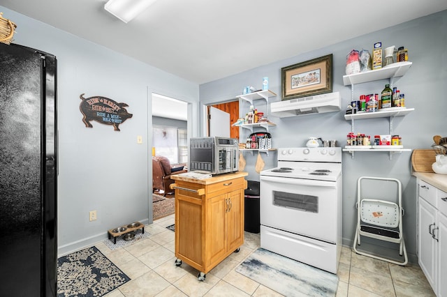 kitchen featuring white electric stove, black refrigerator, white cabinets, and light tile patterned floors
