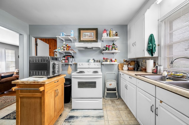 kitchen with sink, white cabinets, light tile patterned floors, and white electric range