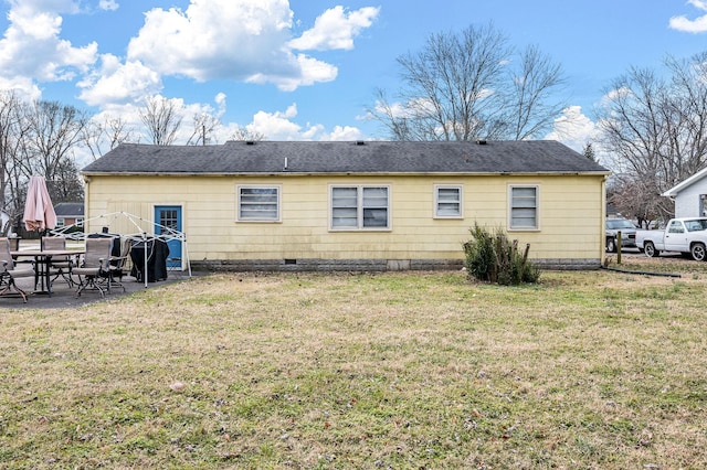 rear view of house featuring a patio and a yard