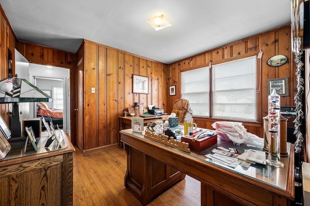 office space featuring light hardwood / wood-style flooring and wooden walls