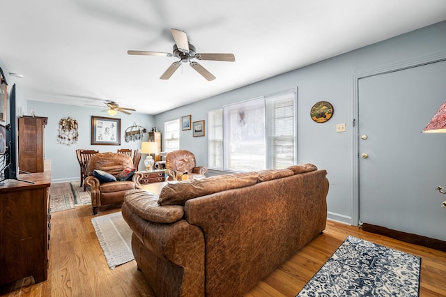 living room with light wood-type flooring and ceiling fan