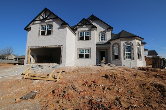 view of front of house with brick siding and a garage