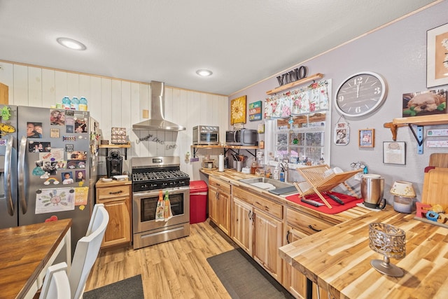 126 Andrea Ln, Monterey, TN 38574 - kitchen featuring appliances with stainless steel finishes, a sink, wood counters, and wall chimney exhaust hood