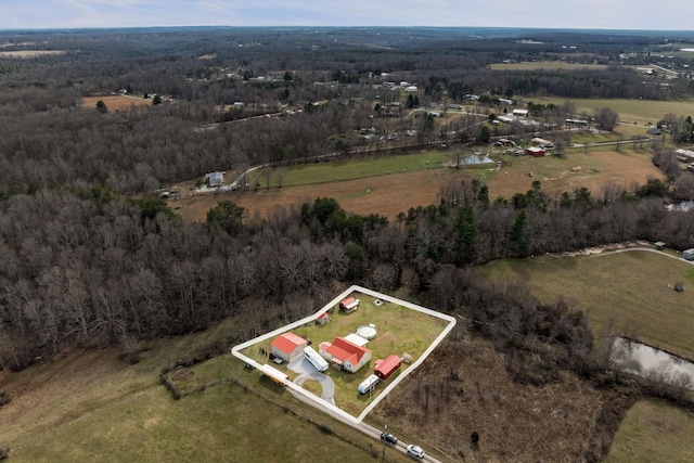 aerial view featuring a view of trees and a rural view