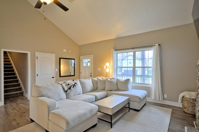 living room with ceiling fan, high vaulted ceiling, and light hardwood / wood-style floors