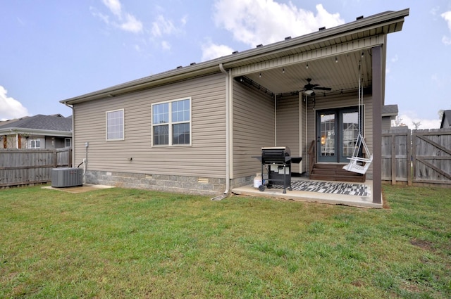 rear view of property featuring central AC unit, a lawn, ceiling fan, and a patio area