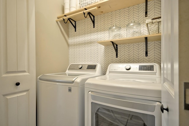 laundry room featuring washing machine and clothes dryer