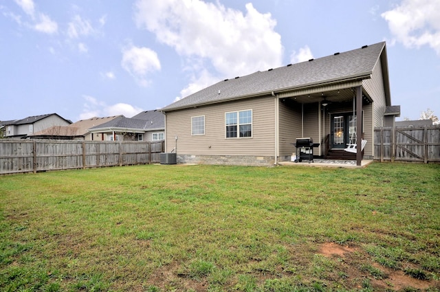 back of house with a yard, cooling unit, and a patio area