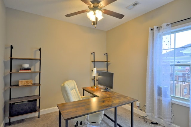 carpeted office space with ceiling fan