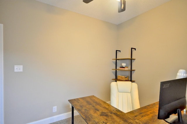 carpeted office space featuring ceiling fan