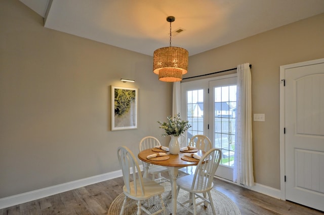 dining room with a wealth of natural light and hardwood / wood-style flooring