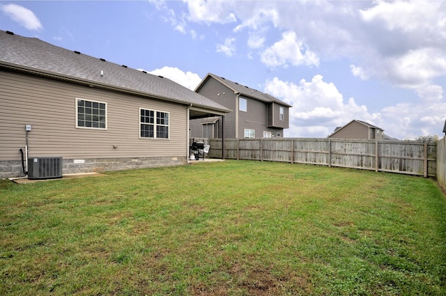 back of property featuring cooling unit and a lawn