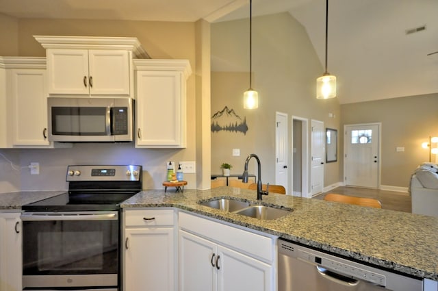 kitchen featuring appliances with stainless steel finishes, sink, light stone counters, white cabinetry, and decorative light fixtures