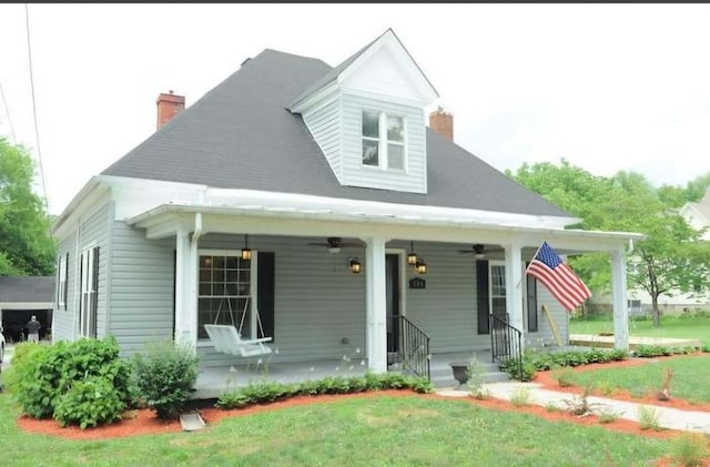 view of front of home featuring covered porch and a front yard