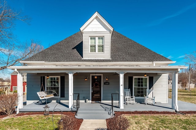 bungalow-style house with a porch and roof with shingles