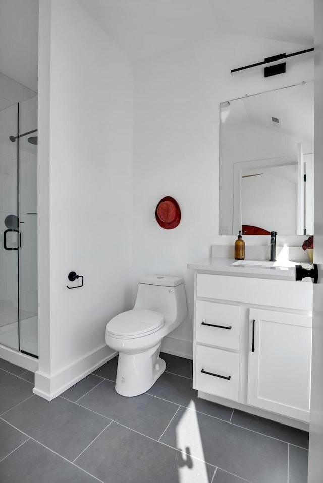 bathroom featuring toilet, a shower with door, lofted ceiling, tile patterned floors, and vanity