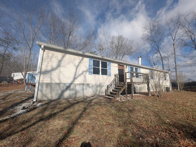 view of front of house with stairway, crawl space, and a deck