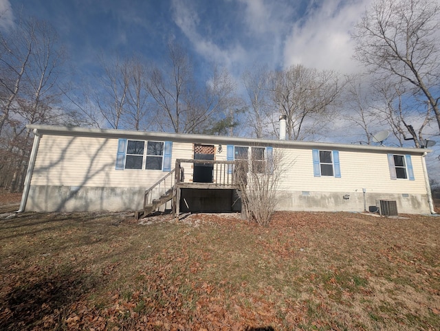 rear view of property featuring crawl space, stairway, central AC unit, and a lawn