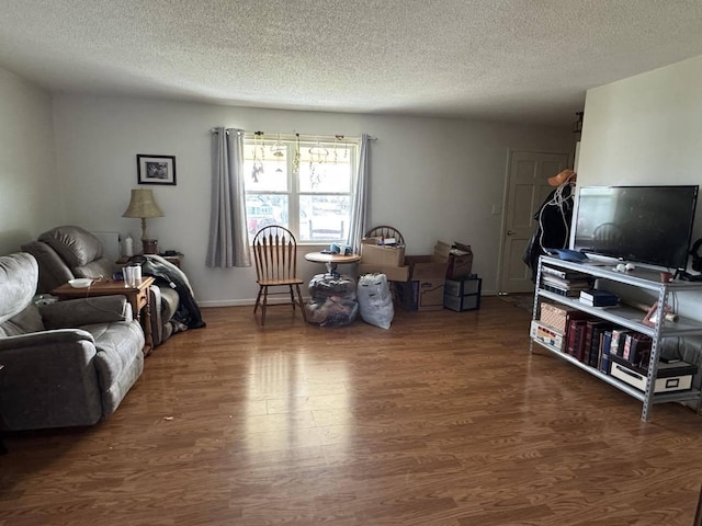 living room featuring dark hardwood / wood-style flooring and a textured ceiling