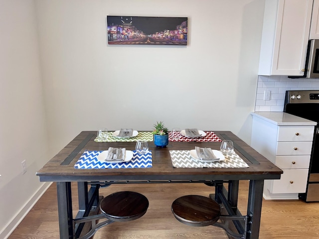 dining space featuring light hardwood / wood-style flooring