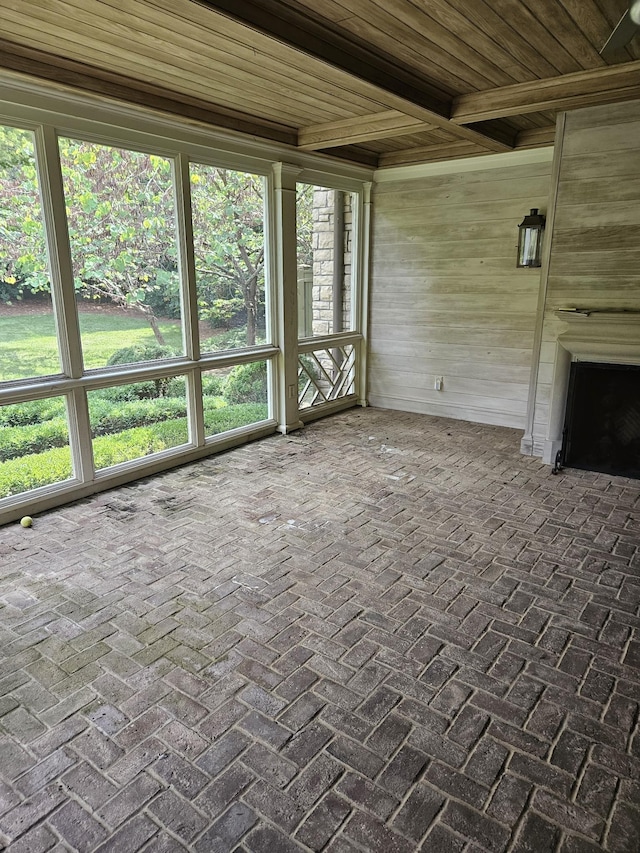 unfurnished sunroom with wooden ceiling