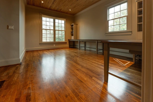 empty room with hardwood / wood-style flooring, crown molding, and wood ceiling