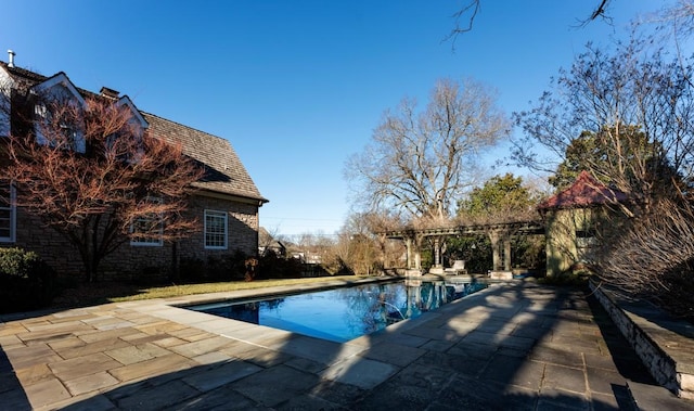 view of swimming pool featuring a patio and a pergola