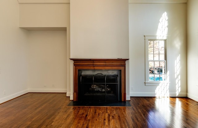 unfurnished living room with dark hardwood / wood-style flooring