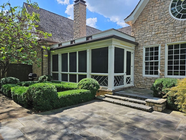 exterior space featuring a sunroom and a patio area