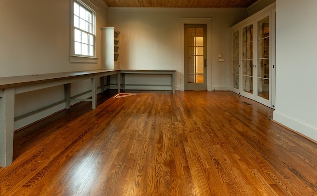 empty room with hardwood / wood-style floors and ornamental molding