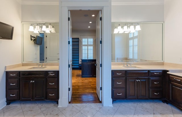 bathroom with ornamental molding, vanity, and tile patterned flooring