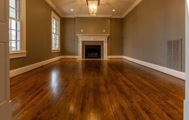 unfurnished living room featuring a fireplace, ornamental molding, and hardwood / wood-style floors