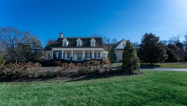 cape cod house featuring a front lawn and a porch