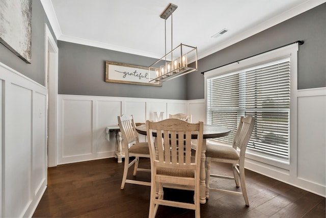 dining space with ornamental molding, dark wood finished floors, visible vents, and a decorative wall