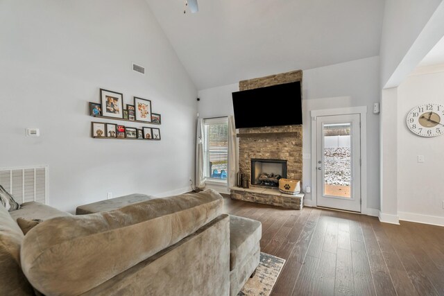 living area with a healthy amount of sunlight, visible vents, and a fireplace