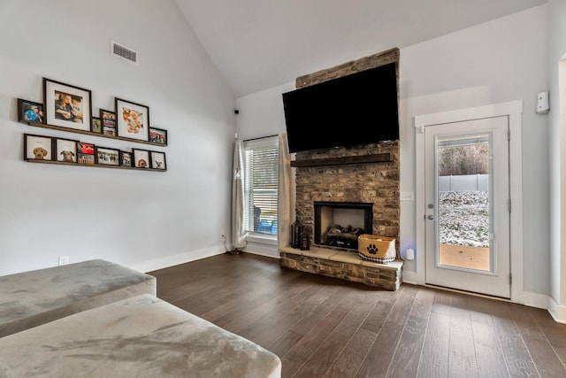 living room with dark wood finished floors, a fireplace, visible vents, high vaulted ceiling, and baseboards