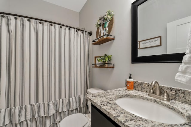 bathroom featuring toilet, a shower with curtain, and vanity