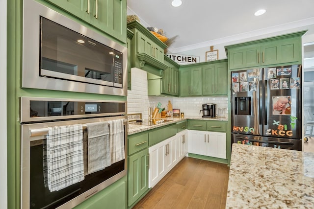 kitchen featuring light wood-style floors, appliances with stainless steel finishes, light stone countertops, tasteful backsplash, and crown molding