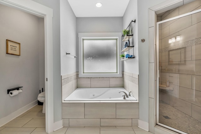 full bath featuring toilet, a shower stall, tile patterned flooring, a whirlpool tub, and baseboards