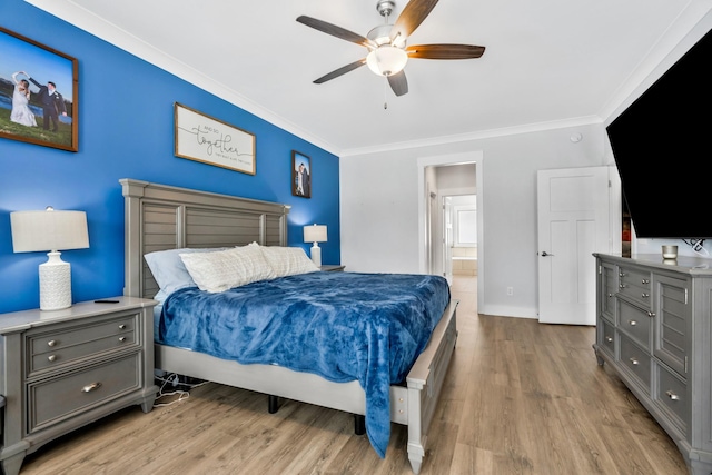 bedroom with light wood-style flooring, ensuite bathroom, ornamental molding, a ceiling fan, and baseboards