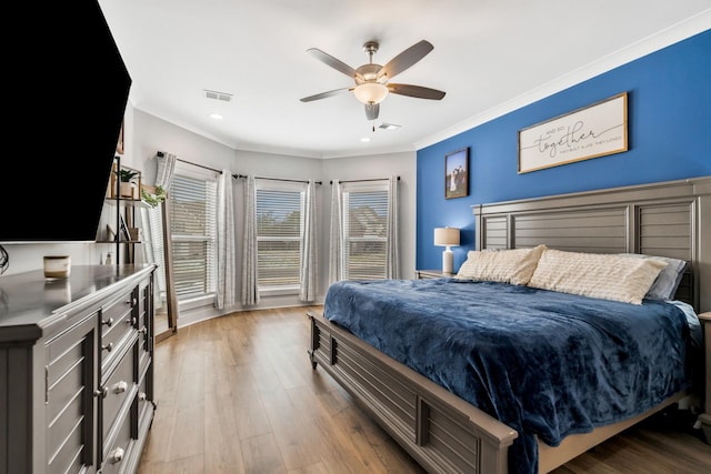 bedroom featuring crown molding, recessed lighting, visible vents, light wood-style flooring, and a ceiling fan